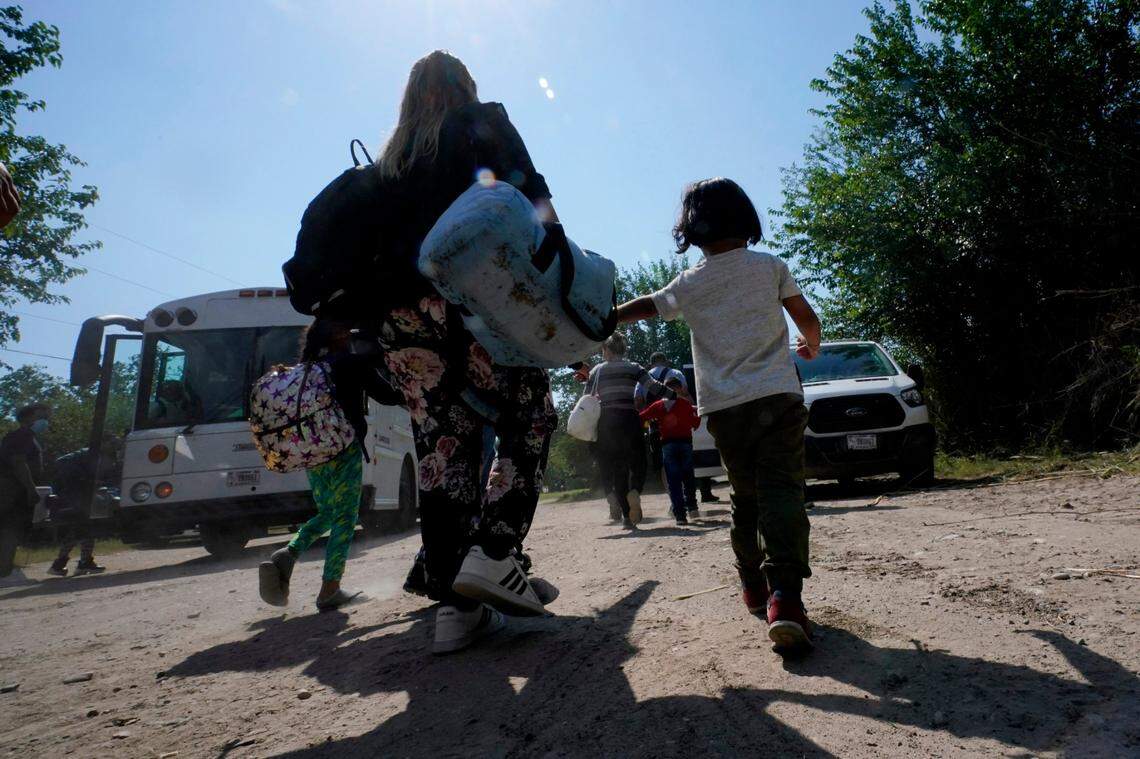 In this June 16, 2021, file photo, a migrant family from Venezuela moves to a Border Patrol transport vehicle after they and other migrants crossed the U.S.-Mexico border and turned themselves in Del Rio, Texas.