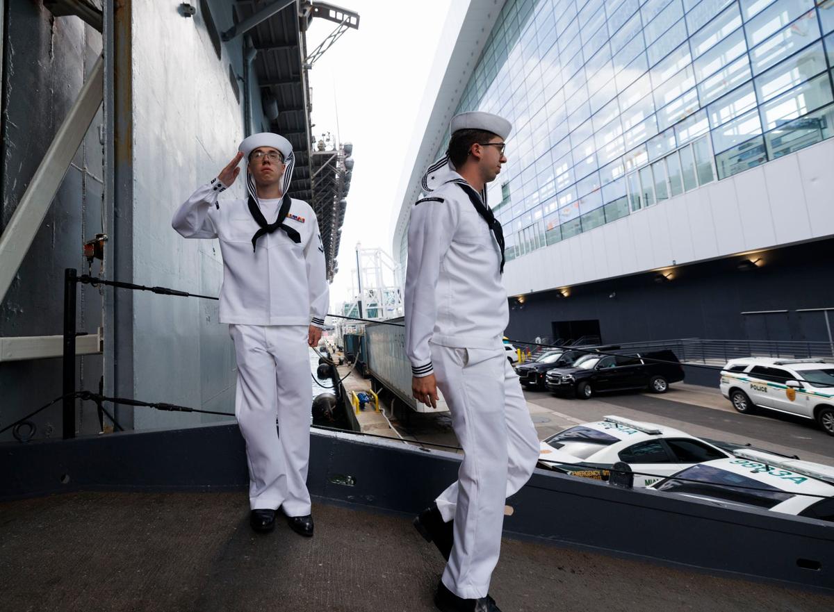Sailors salute as they board the USS Bataan during the opening day of Fleet Week on Monday, May 6, 2024, at Norwegian Cruise Lines Terminal in PortMiami.