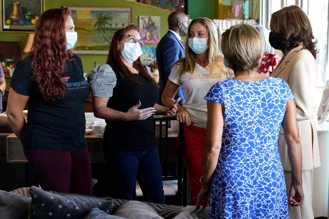 Vice President Kamala Harris, far right, talks with Cheyanne Tanner, left, Danielle Estes, center, and Laura McMurry, right, while visiting the Dragonfly Thrift Boutique, Monday, Aug. 1, 2022, in the Little Havana neighborhood of Miami. Harris stopped by the store while in Miami attending climate resilience events. (AP Photo/Lynne Sladky)