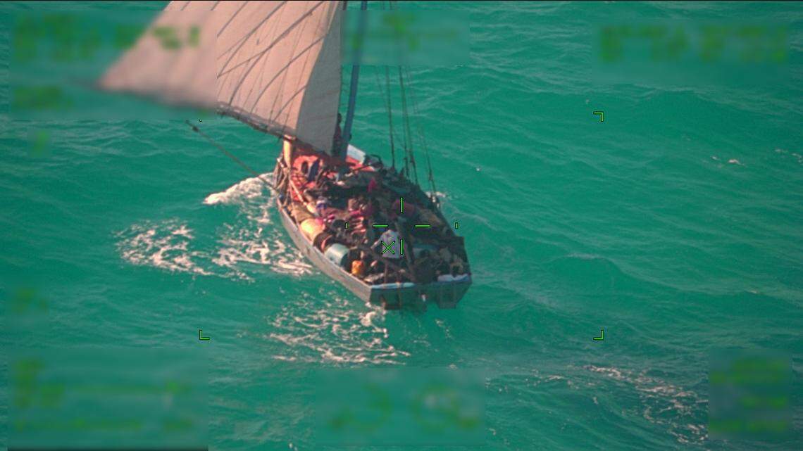 A photo taken from a U.S. Coast Guard aircraft shows a sailboat packed with 132 people from Haiti off the coast of Andros Island in the Bahamas on Sunday, April 18, 2022.