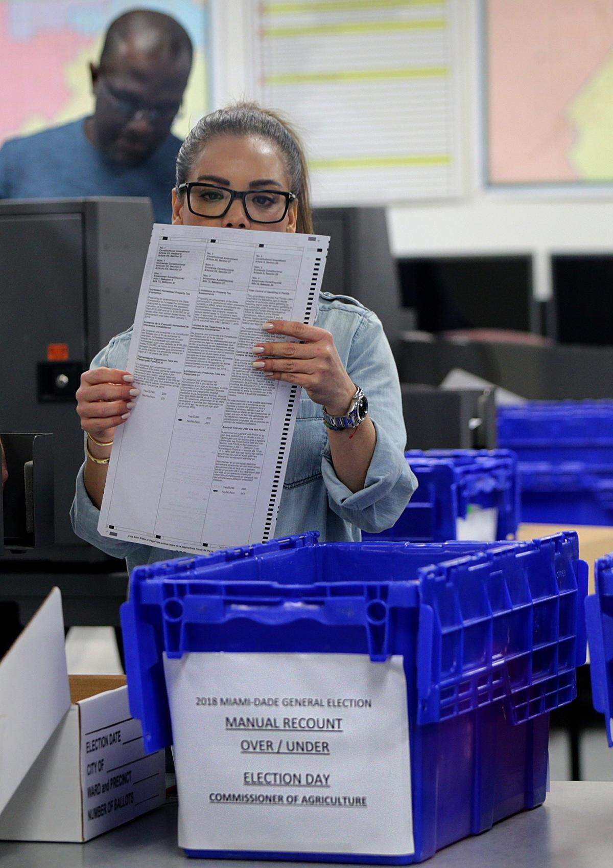 Miami-Dade County Election department staff members work on ballots for the manual recount over/under votes for commissioner of agriculture in Doral on Saturday November 17, 2018