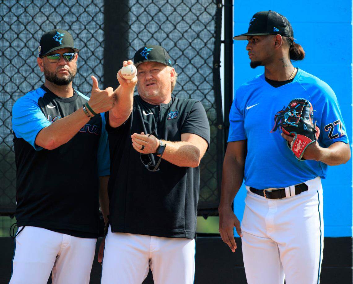 Miami Marlins bullpen coach Wellington Cepeda and Marlins pitching coach Mel Stottlemyre Jr. talks with Marlins pitcher Edward Cabrera throws during their spring training workout at Roger Dean Stadium on Wednesday, March 16, 2022 in Jupiter, FL.