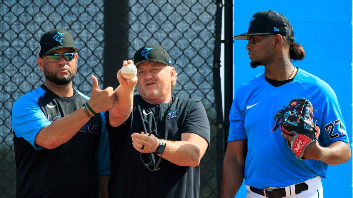 Miami Marlins bullpen coach Wellington Cepeda and Marlins pitching coach Mel Stottlemyre Jr. talks with Marlins pitcher Edward Cabrera throws during their spring training workout at Roger Dean Stadium on Wednesday, March 16, 2022 in Jupiter, FL.
