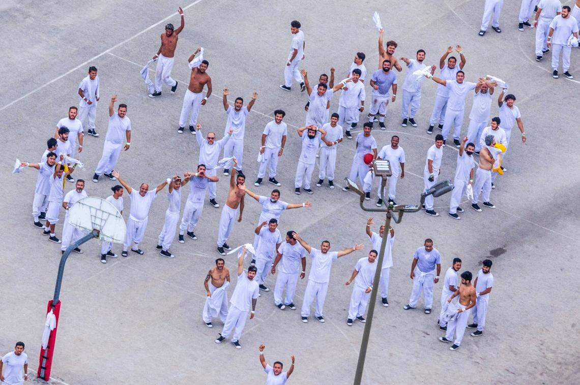 Detainees reacts as they stand at the recreational areas at the Krome Detention Center in West Miami,, Florida on Friday July 04, 2025.