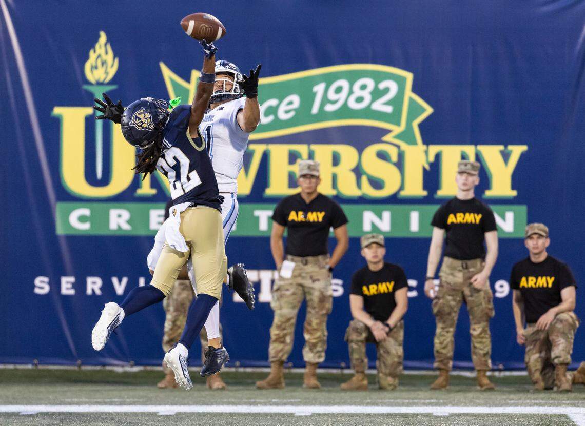 FIU Panthers defensive back Brian Blades (22) blocks a throw to Maine Black Bears wide receiver Montigo Moss (81) in the second quarter of their NCAA DI football game at the FIU Football Stadium on Saturday, Sept. 2, 2023, in Miami, Fla.