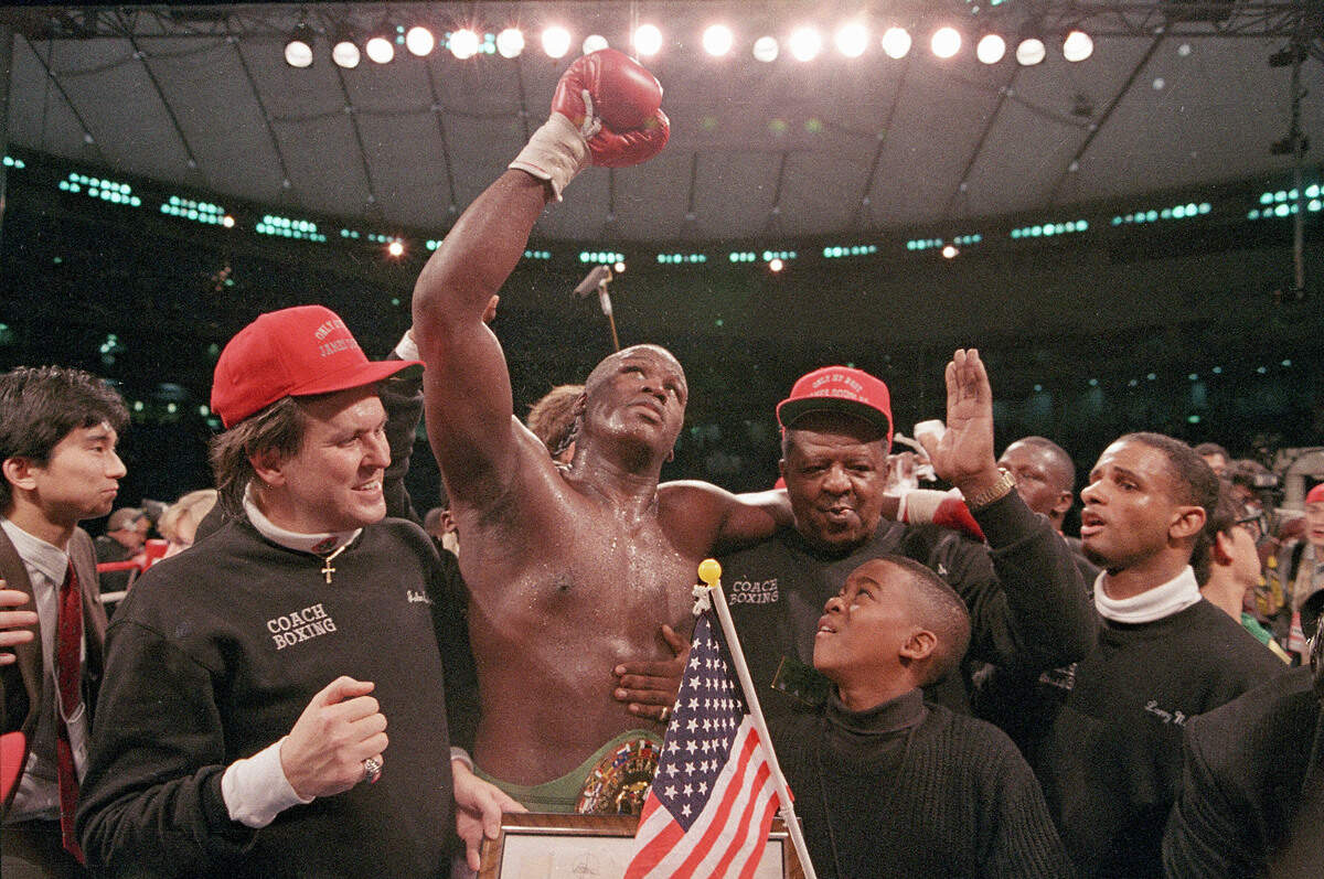Heavyweight boxer James "Buster" Douglas waves his gloved hand to the cheering crowd following a 10th round knockout victory over Mike Tyson in a scheduled 12-round championship bout at the Tokyo Dome in 1990.