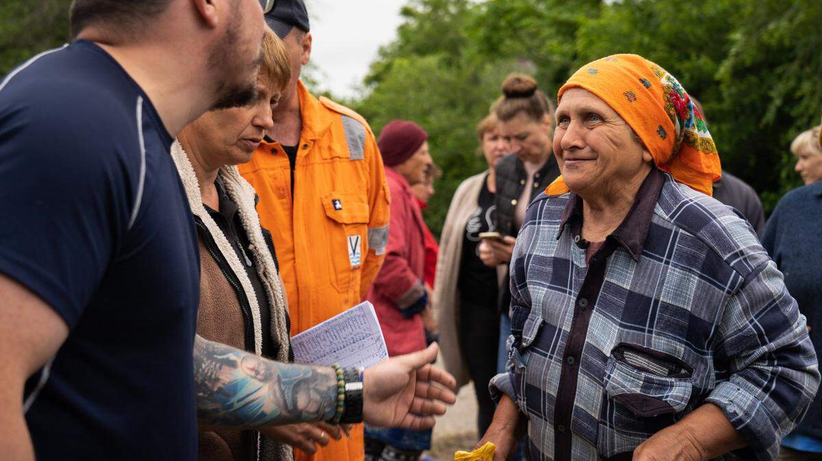 A resident takes humanitarian aid from volunteers in Mykhailivka in Ukraine.