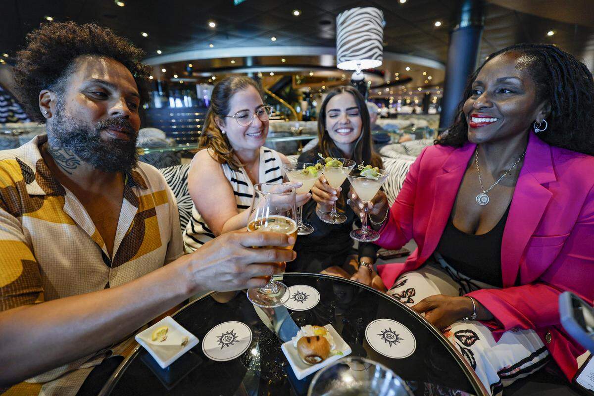 Carlos Omar Gardinet, Lyssa Goldberg, Melissa Puppo, Lahoma Scarlette, toast at the Zebra Bar on MSC Poesia at PortMiami in Miami, Florida, on Wednesday, April 22, 2026. Built in 2008, it underwent refurbishment this year. This winter, it will be based at PortMiami heading on trips to the Caribbean. Bar
