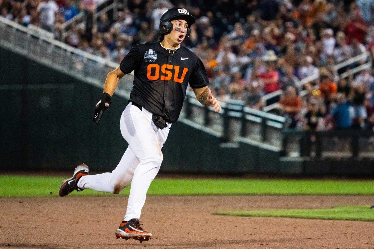 Jun 13, 2025; Omaha, Neb, USA; Oregon State Beavers shortstop Aiva Arquette (13) heads to third on a walk off RBI double against the Louisville Cardinals during the ninth inning at Charles Schwab Field. Mandatory Credit: Dylan Widger-Imagn Images