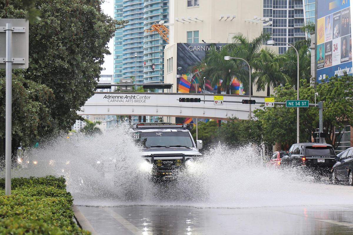 An SUV drives through flooded Biscayne Boulevard and NE. 14th Street. in Downtown Miami, Florida, Sunday, June 16, 2019.