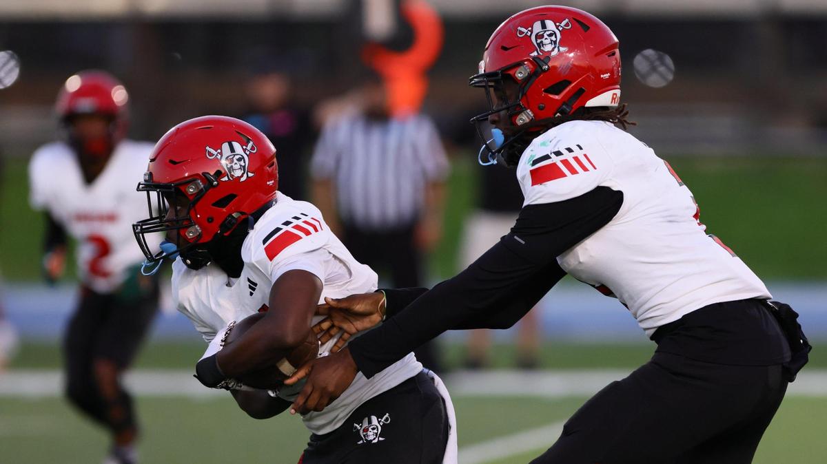 Edison Red Raiders running back Sterling Joseph (4) takes a handoff from quarterback Emmanuel Poitier Jr (3) against the True North Titans during the first quarter of a high school football Class 1A Region 4 playoff game at Tropical Park in Miami, Florida, on Thursday, November 21, 2024.