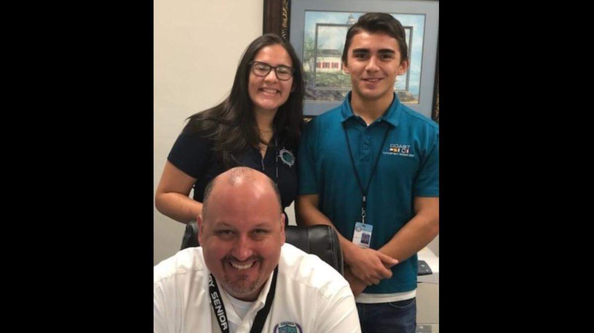 Kristina Alzugaray and Damien Martinez of Cutler Bay High School were recently named finalists in the 2019 National College Match QuestBridge Scholarship Program. The students are pictured with Principal Lucas De La Torre.