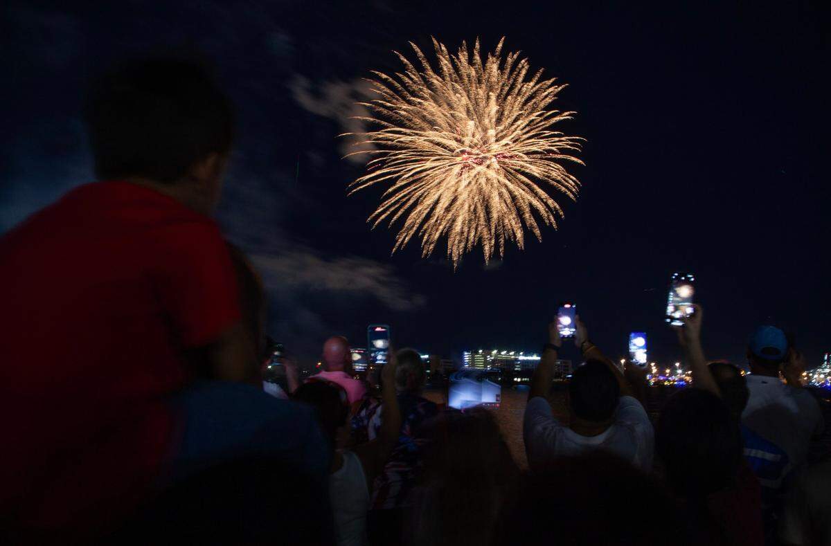 Attendees watch the fireworks during the Fourth of July Bayfront Park Celebration at Bayfront Park on Tuesday, July 4, 2023 in Miami, Fla.