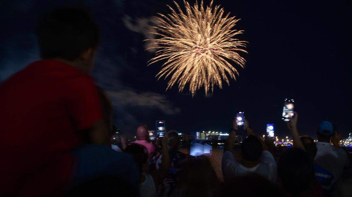 Attendees watch the fireworks during the Fourth of July Bayfront Park Celebration at Bayfront Park on Tuesday, July 4, 2023 in Miami, Fla.