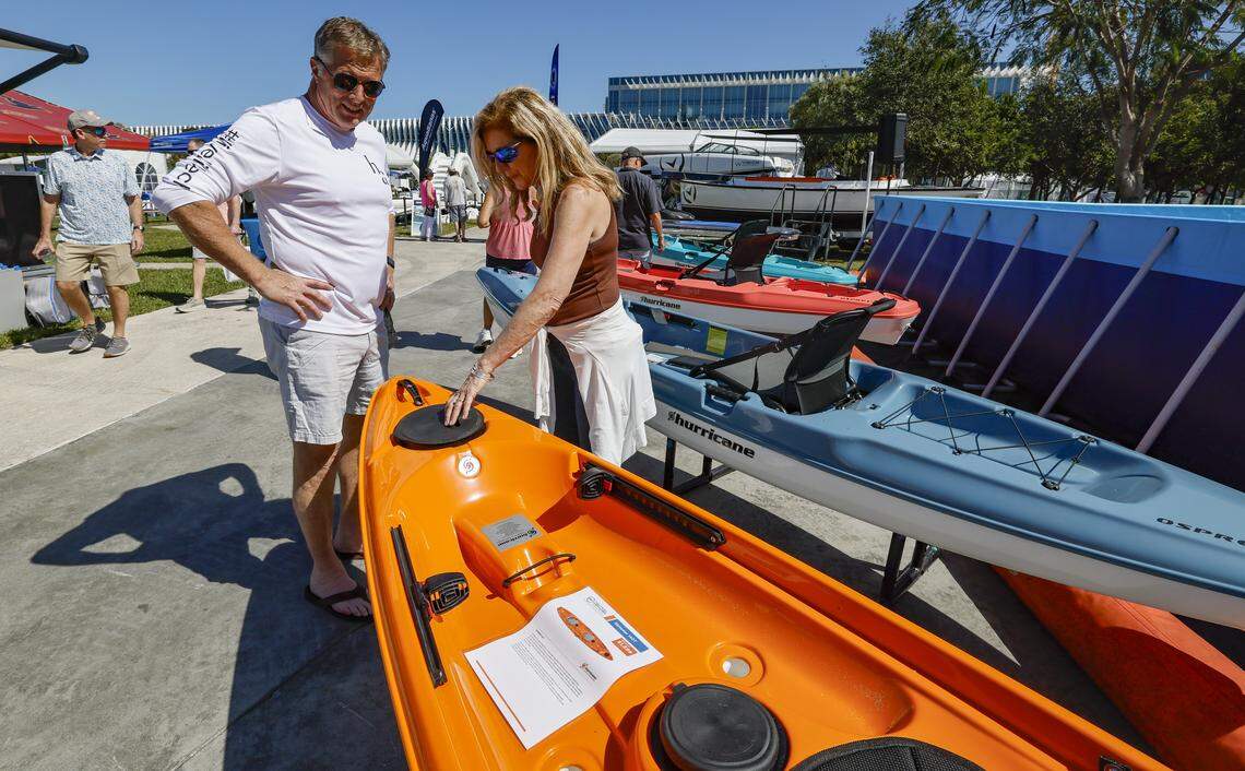 Ken and Christy Rieder, left to right, of Cincinnati view the kayas on display during the Miami Beach International Boat Show outside the Miami Beach Convention Center on Miami Beach, Florida on Thursday, February 12, 2026.