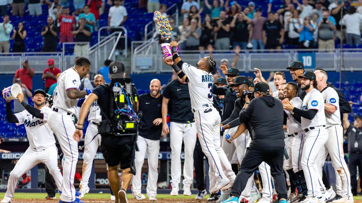 Miami Marlins players greet designated hitter Jorge Soler (12) at home plate after he hit a walk-off two-run homerun to defeat the Washington Nationals 5-4 during the ninth inning of an MLB game at loanDepot park in the Little Havana neighborhood of Miami, Florida, on Tuesday, May 16, 2023.