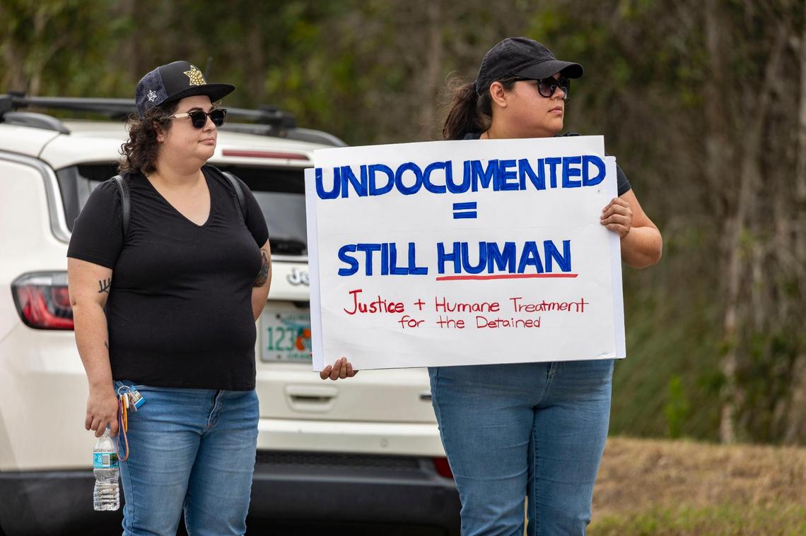 Left to right, Nicole Cubillas and Alejandra Alvarez, both Miami residents, protest outside the Krome Detention Center on Saturday, March 29.