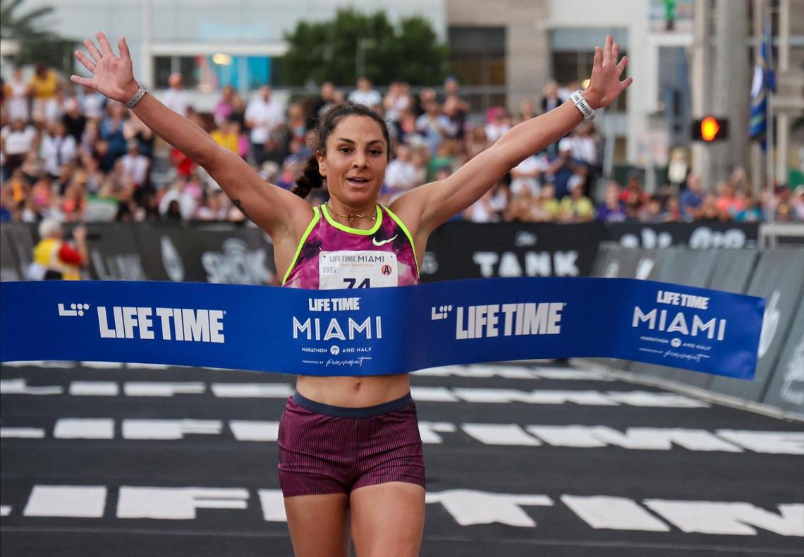 American runner Nell Rojas lifts her arms as she wins the Half Marathon as over 18,000 athletes and runners participated in the 2025 Life Time Miami Marathon and Half on February 2, 2024, in downtown Miami, Florida.