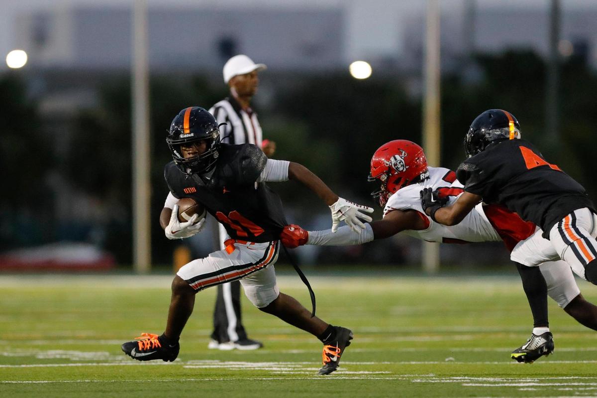 Booker T. Washington wide receiver Anton Smith (11) runs with the football against the Edison Red Raiders during the second quarter of a high school football game at Traz Powell Stadium in Miami Florida, Monday, October 16, 2023.
