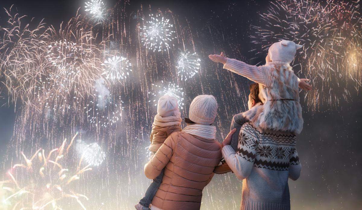 family watching fireworks on new year's eve