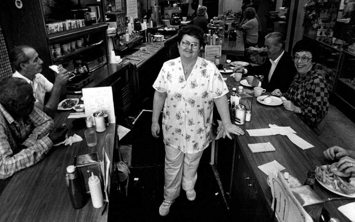 Waitress Helen Boundreau waits on customers at Moderne Drugs on 41st Street in 1984.