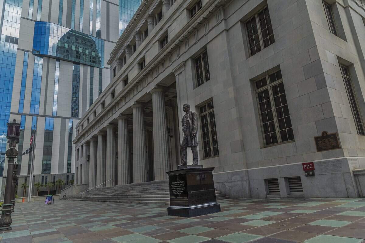 A statue of industrialist Henry Flagler, who co-founded the city of Miami, stands at the main entrance to the historic and abandoned Miami-Dade County Courthouse which opened in 1928, that has been up for sale for years, but the county can't find a buyer at the right price, in downtown Miami, Florida on Tuesday, June 30, 2026.