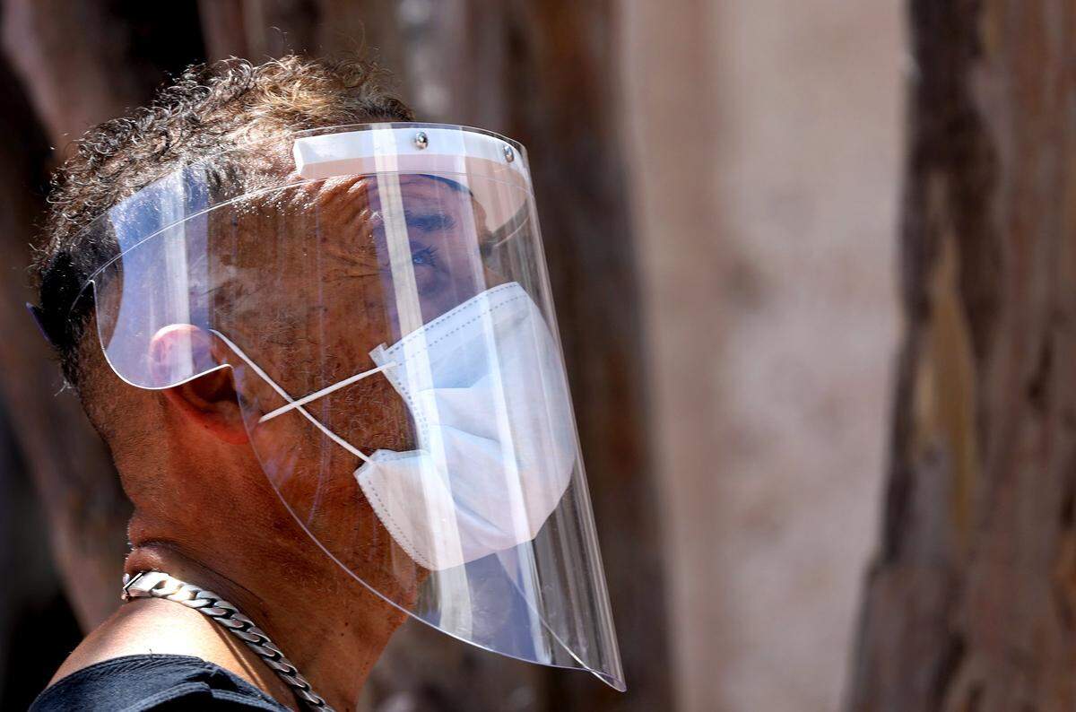 Businesses throughout Lincoln Mall are closed but few beach residents, workers, and visitors ventured outside with masks (PPE) while some continue to work and stroll without on Tuesday, April 7, 2020.