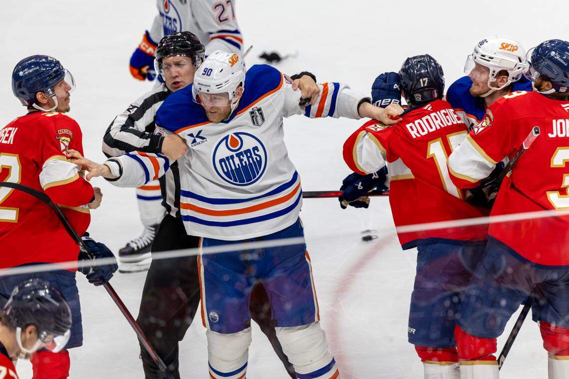 NHL linesman Scott Cherrey (50) restrains Edmonton Oilers right wing Corey Perry (90) as teammate John Klingberg (36) attempts to engage Florida Panthers left wing Tomas Nosek (92), with Panthers center Evan Rodrigues (17) and defenseman Seth Jones (3) nearby, following Florida’s 6-1 win over Edmonton in Game 3 of the Stanley Cup Final at Amerant Bank Arena on Monday, June 9, 2025, in Sunrise, Fla.