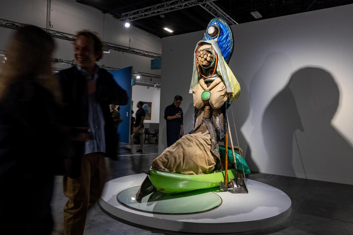 Miami Beach, Florida, December 6, 2023 - A work titled Centinelas de la Luna Negra by artist Daniel Lind-Ramos which is made from items such a FEMA tarp, a green canoe, rope, PVC tubing, metal wiring and burlap sacks just to name a few can be yours for $375,000.00. The work is on display at the Miami Beach Convention Center during Art Basel VIP day.