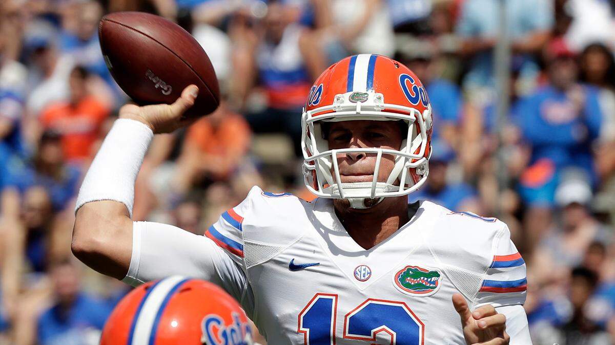 Florida quarterback Feleipe Franks (13) throws a pass over defensive lineman Cece Jefferson, left, during an NCAA college spring football intrasquad game, in Gainesville, Fla. Florida coach Dan Mullen is expected to name a starting quarterback for Saturday’s season opener against Charleston Southern. The decision is between Feleipe Franks and Kyle Trask.