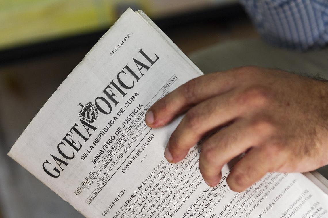 Cuban artist Luis Puerta Batista reads through a copy of Decree Law 349 at his studio in Old Havana.