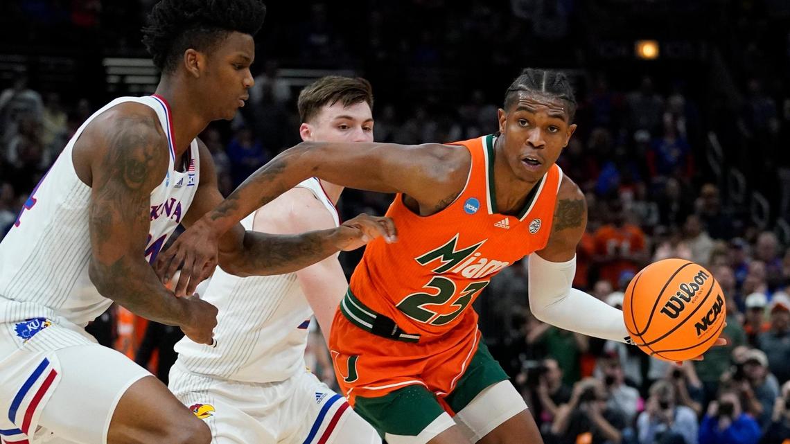 Miami’s Kameron McGusty tries to get past Kansas’ K.J. Adams during the first half of a college basketball game in the Elite 8 round of the NCAA tournament Sunday, March 27, 2022, in Chicago. (AP Photo/Nam Y. Huh)
