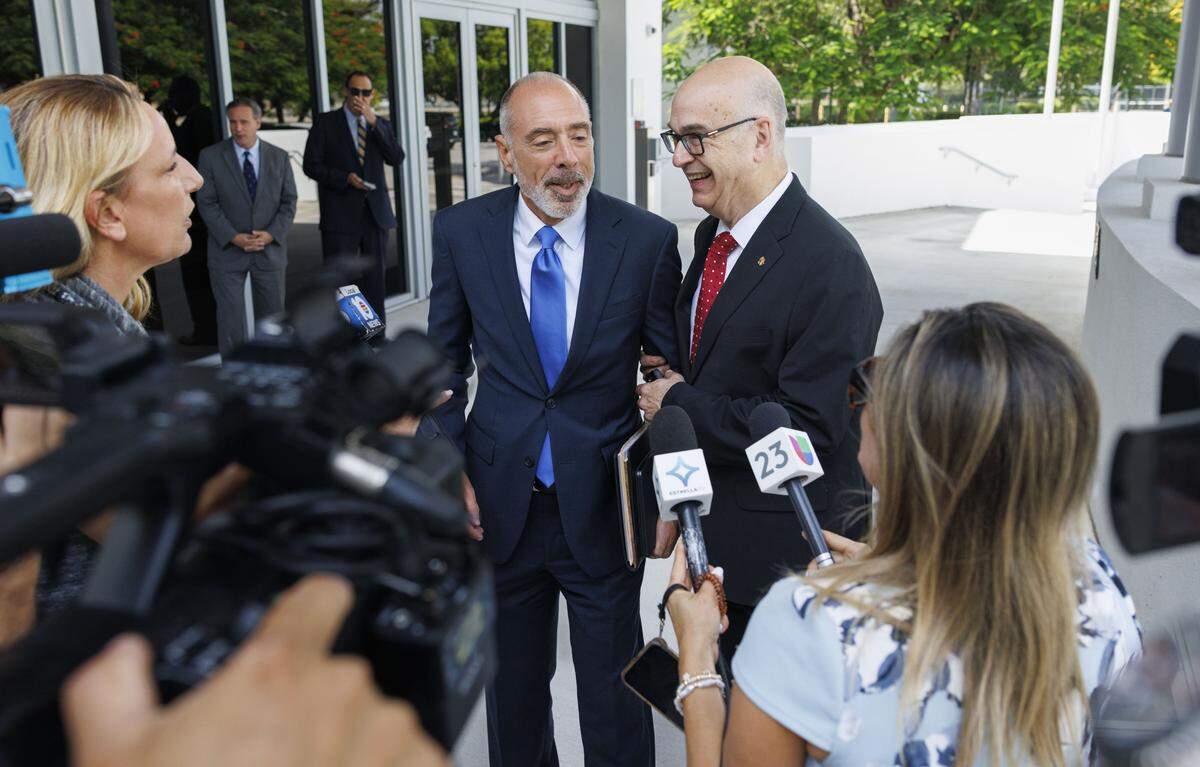 Emilio González, right, and his attorney Alan Lawson, center, hold a press conference after a hearing at the Third District Court of Appeal for a case Emilio González brought against the City of Miami on Tuesday, July 29, 2025, in Miami. A lower court judge ruled in favor of González, declaring the city's ordinance to be unlawful. The judge said changing the election date requires amending the City Charter, which requires voter approval. The city appealed the decision.