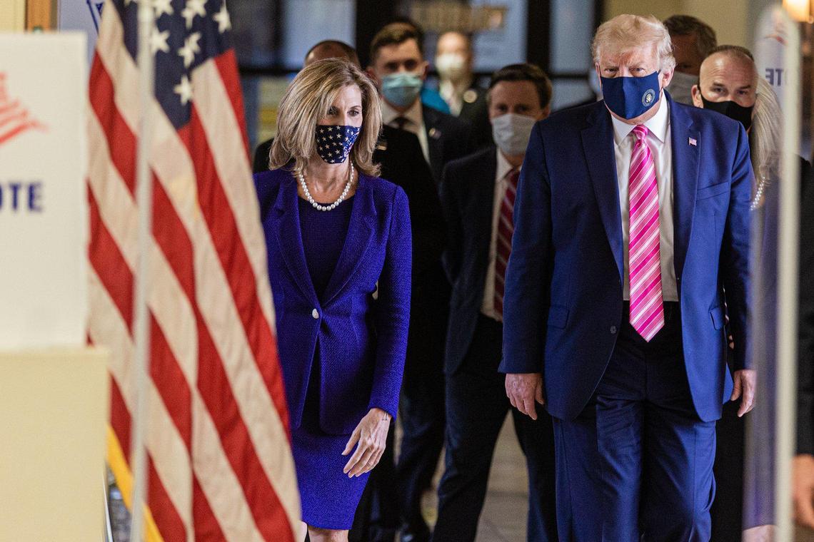 President Donald J. Trump (right) leaves the voting area with Palm Beach County Supervisor of Elections Wendy Sartori Link. The President cast an early ballot for the 2020 presidential election at the main branch of the Palm Beach County library on Summit Blvd. in West Palm Beach, Saturday October 22, 2020. When asked who he voted for, the President replied, Some guy named Trump. (JOSEPH FORZANO / THE PALM BEACH POST)