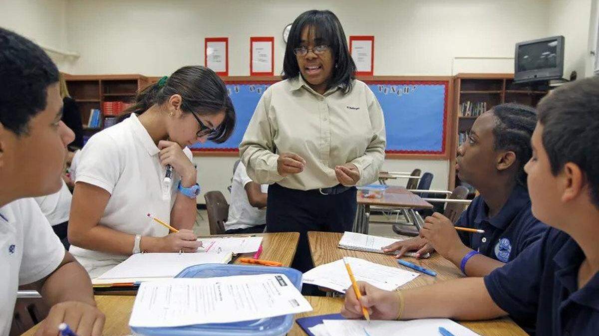 Math teacher Phyllis Bellinger, in 2012, talks with students at Ponce de Leon Middle School in Coral Gables.