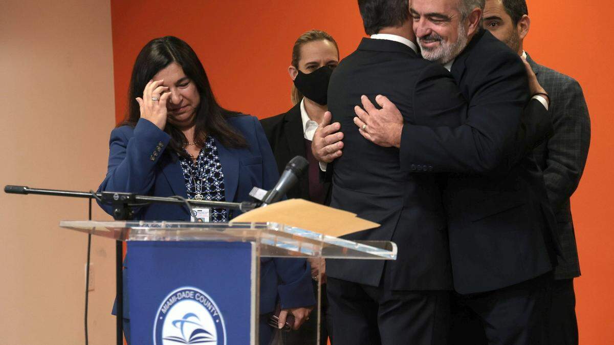 Miami-Dade Schools Superintendent Alberto Carvalho embraces members of his staff on Dec. 9, 2021, prior to announcing his departure to become the superintendent of the public schools in Los Angeles.