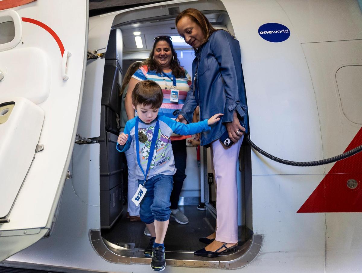 Leonard Frost, 4, deplanes during the MIAair tour at the Miami International Airport on Monday, Oct. 23, 2023, in Miami, Fla. The MIA Airport Instruction and Readiness tour allows about 25 children with special needs to walk through an airport travel experience from start to finish in a safe and controlled environment.