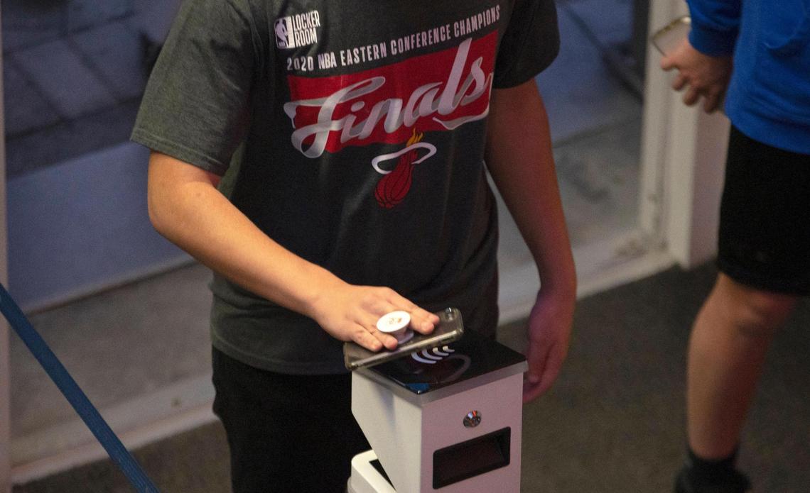 Fans scanning their digital tickets before the start of an NBA basketball game between the Miami Heat against the Golden State Warriors at the AmericanAirlines Arena on Thursday, April 1, 2021 in Miami, Fl. The Heat increase the number of fans allowed to attend games at AmericanAirlines Arena to about 4,000 just about 20 percent of the building’s usual capacity of 19,600.