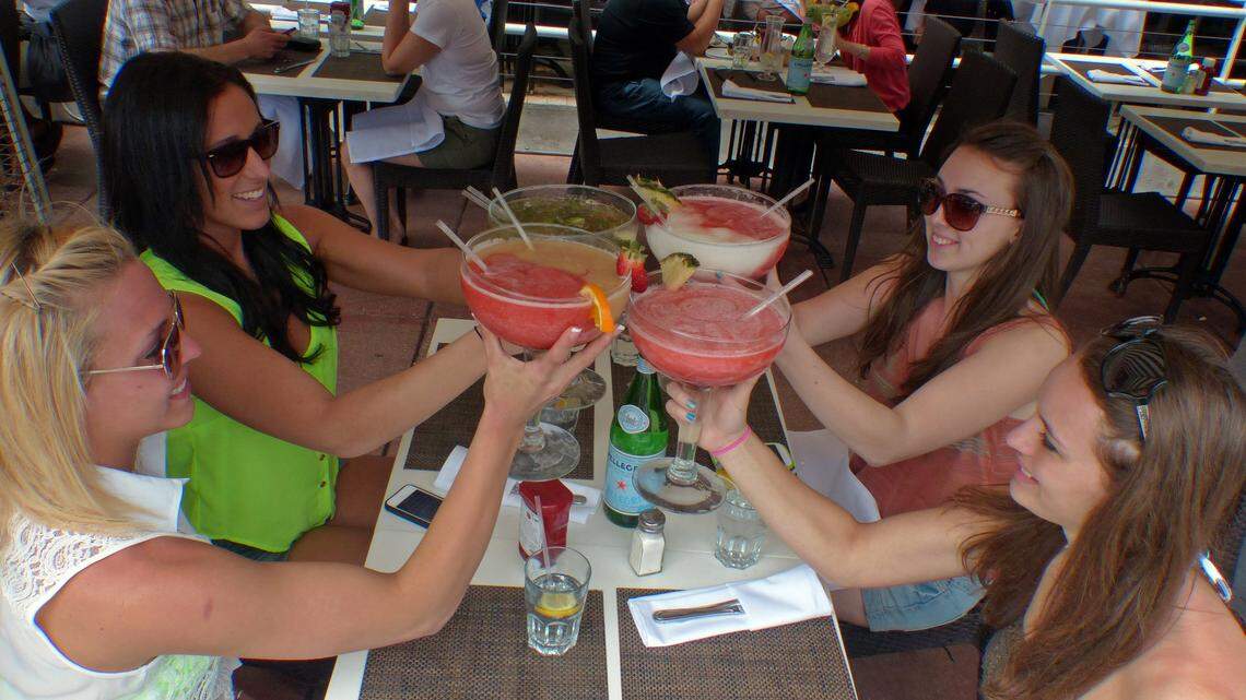 Montclair State University students enjoy large drinks along Ocean Drive on South Beach during spring break in 2013.