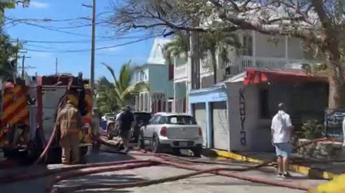 Firefighters deal with the aftermath of a fire near Duval Street in Key West Monday, Feb. 27, 2023.