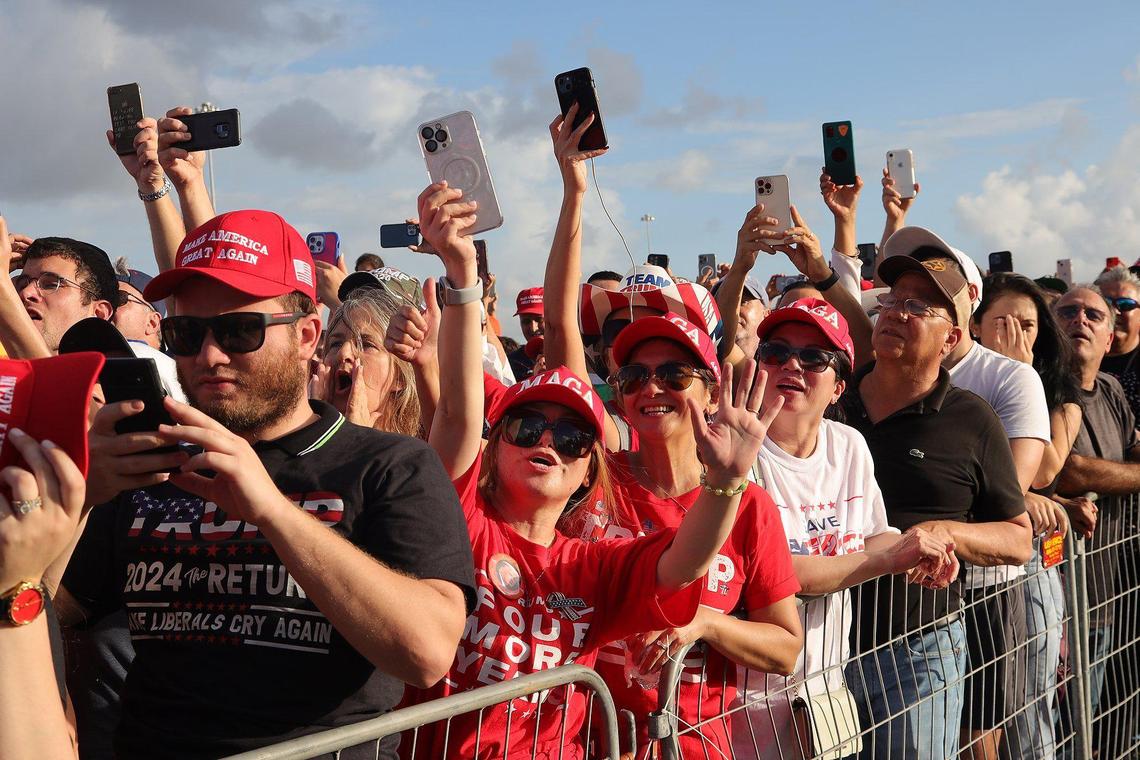 Supporters of former President Donald Trump begin to cheer his arrival after waiting for several hours to see him at the Miami-Dade County Fair and Exposition on Sunday, November 6, 2022. Trump and a collection of other national and local Republicans campaigned with U.S. Sen. Marco Rubio on the eve of the Nov. 8 election.
