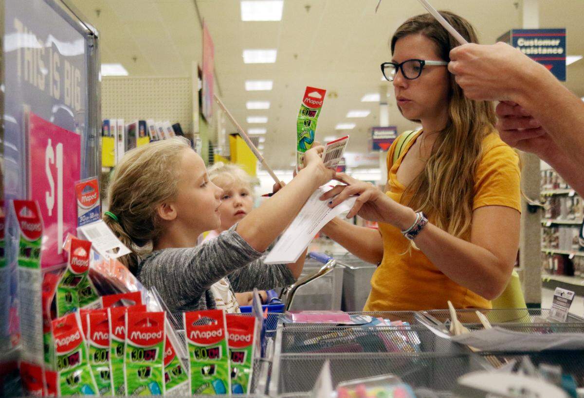 Norah Johnson, 8, shows her mother Tracy a flexible ruler as they shop for back-to-school supplies on Wednesday, Aug. 1, 2018, at Shopko in West Bend, Wisconsin.  The sales tax holiday weekend in Florida runs Aug. 3-5, 2018.