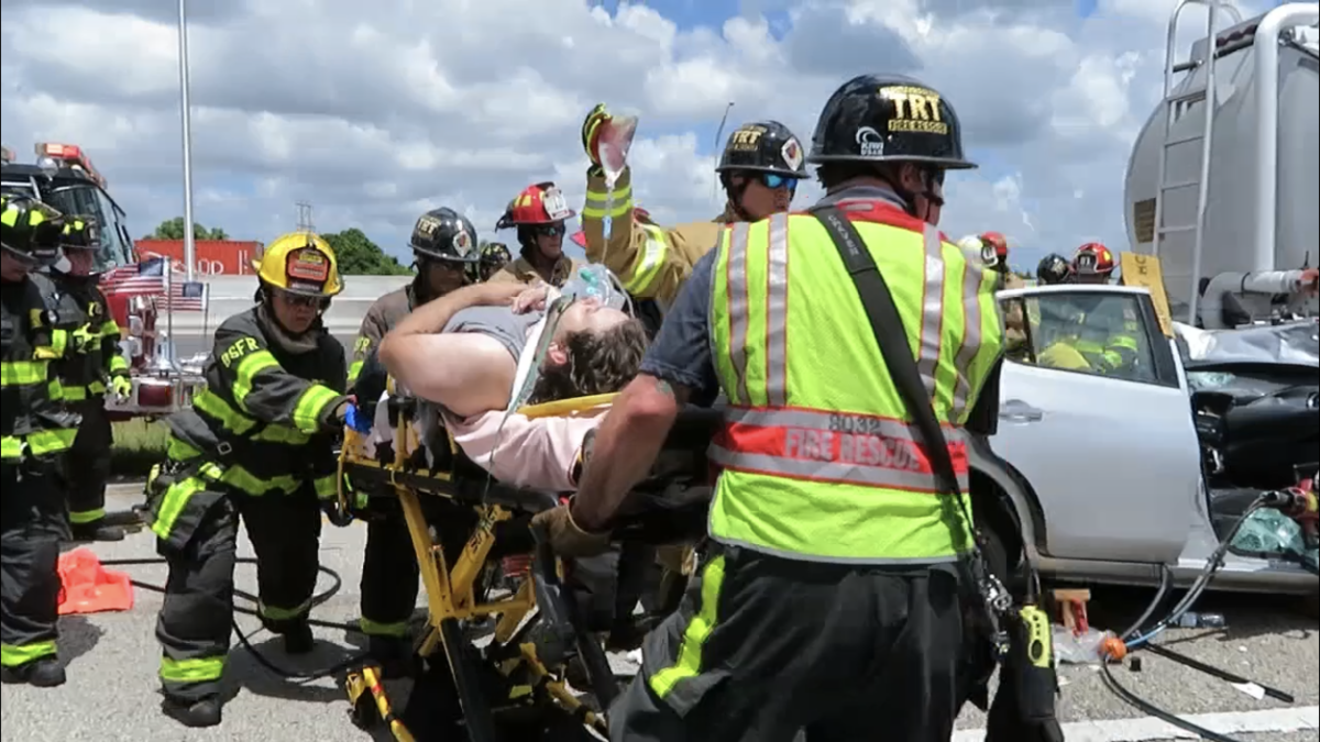 A man is removed from his car after he crashed into a tanker truck on I-75 Friday afternoon.