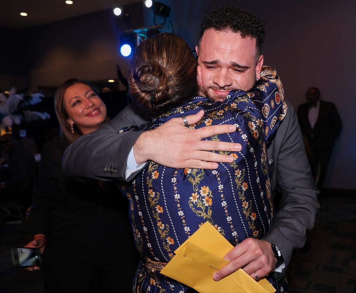 Kristian Jose Luciano of Homestead Middle School, right, is congratulated by colleagues after winning 2027 Francisco R. Walker Rookie Teacher of the Year at the DoubleTree by Hilton Hotel Miami Airport & Convention Center on Wednesday, January 28, 2026, in Miami, Florida. 