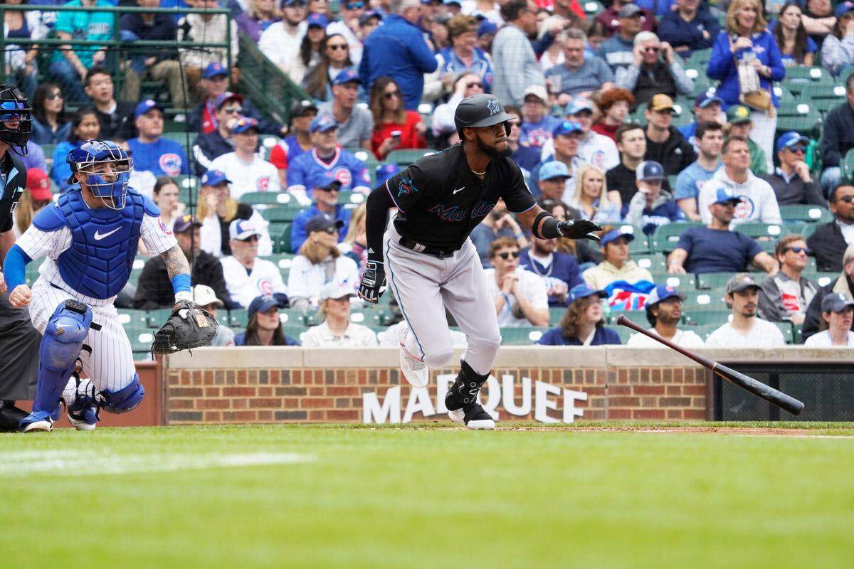 Miami Marlins left fielder Bryan De La Cruz (14) hits an RBI single against the Chicago Cubs during the first inning at Wrigley Field on Saturday, May 6, 2023.