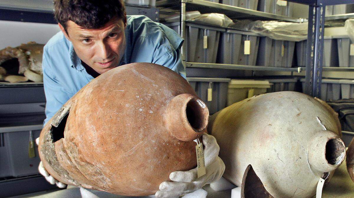 Corey Malcom, director of archaeology for the Mel Fisher Maritime Heritage Society, prepares a 17th-century ceramic olive jar for exhibition Tuesday, July 19, 2005, in Key West. The artifact was found on the “main pile” site of the 1622-shipwrecked Spanish galleon Nuestra Senora de Atocha.