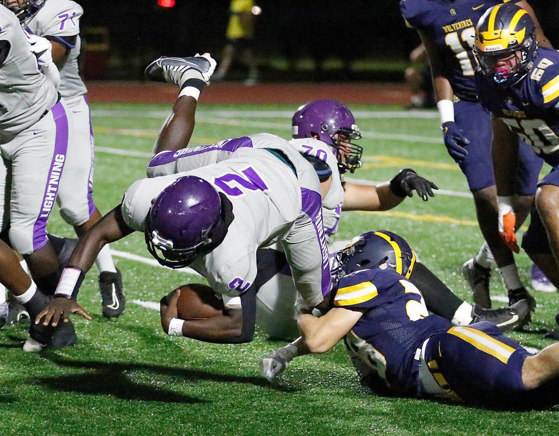Dr. Krop Lightning running back Julius Pascal (2) is taken down by Belen Jesuit Wolverines defenders during football game on Friday, November 11, 2022 at Monsignor Pace HS in Miami. Andrew Uloza / for Miami Herald