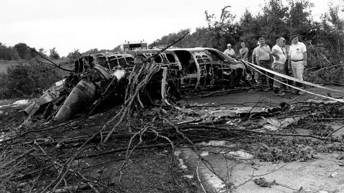 Rescue workers inspect the wreckage of a Cessna Citation airplane in Akron, Ohio, on August 2, 1979. New York Yankees catcher Thurman Munson, piloting the plane, was killed in the crash. Two passengers survived. (AP Photo/Madeline Drexler)
