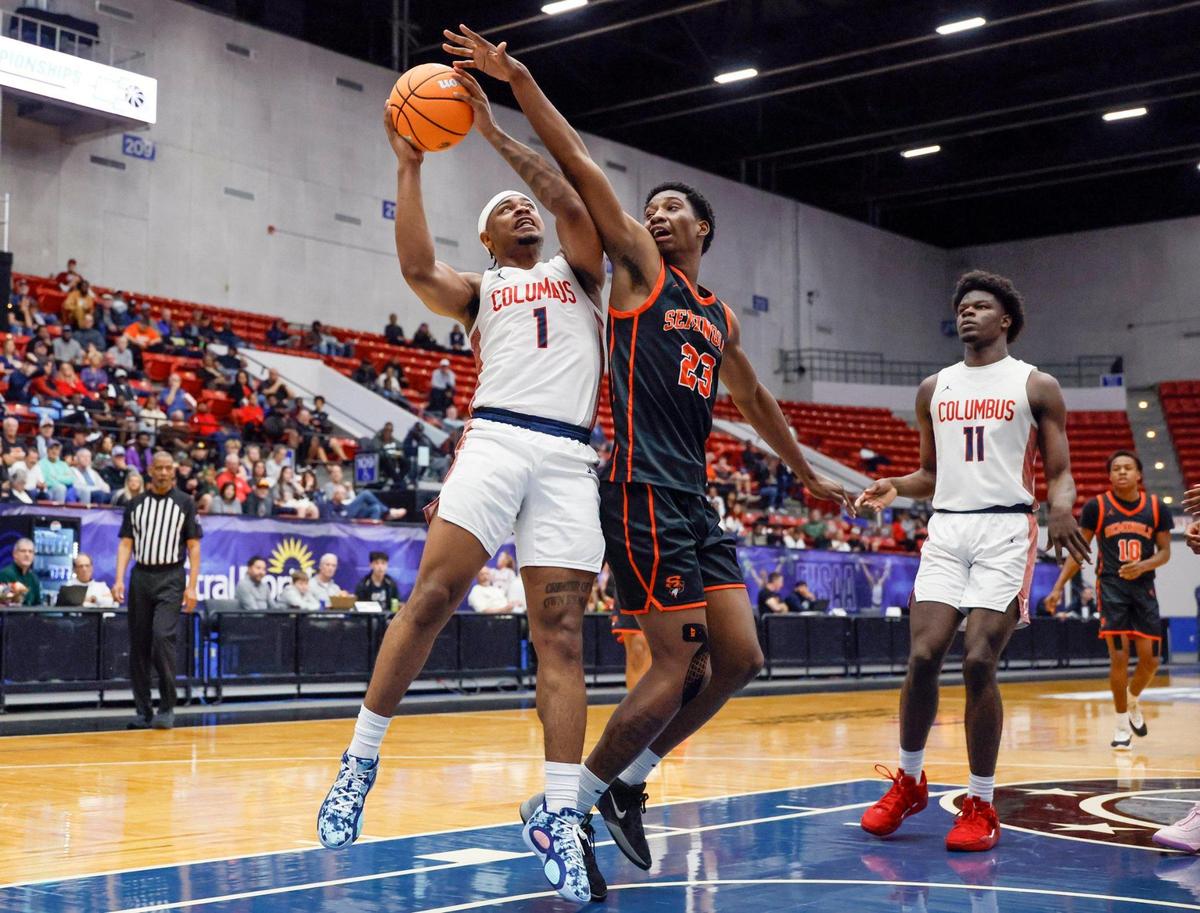 Columbus’ Cello Jackson (1) attempts to score as Seminole’s Markel Barber (23) defends in the second half of the Class 7A state semifinal at the RP Funding Center in Lakeland, Florida on Friday, March 7, 2025.