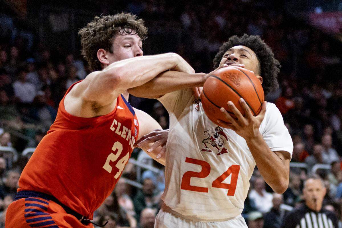 Miami Hurricanes guard Nijel Pack (24) drives on University of Clemson center PJ Hall (24) during the second half of an NCAA basketball game at the Watsco Center in Coral Gables, Florida, on Wednesday, January 3, 2024.